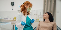 Smiling patient talking to dentist in treatment chair
