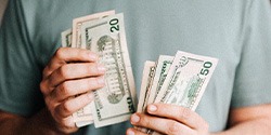 Close up of man’s hands counting cash