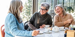 a group of older women laughing and conversing