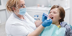 A boy getting fluoride treatment