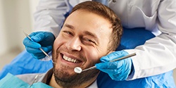 A man smiling at a dental checkup
