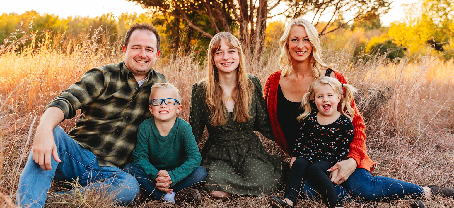 Edmond dentist Doctor Patrick Crowley sitting with his family outdoors