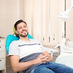 Happy dental patient reclining in treatment chair